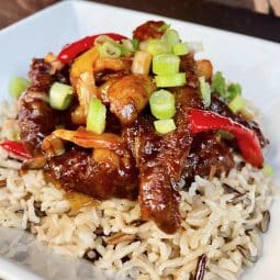 a plated dish of crispy chilli beef and rice