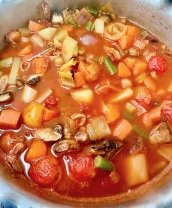 minestrone soup simmering in a pan