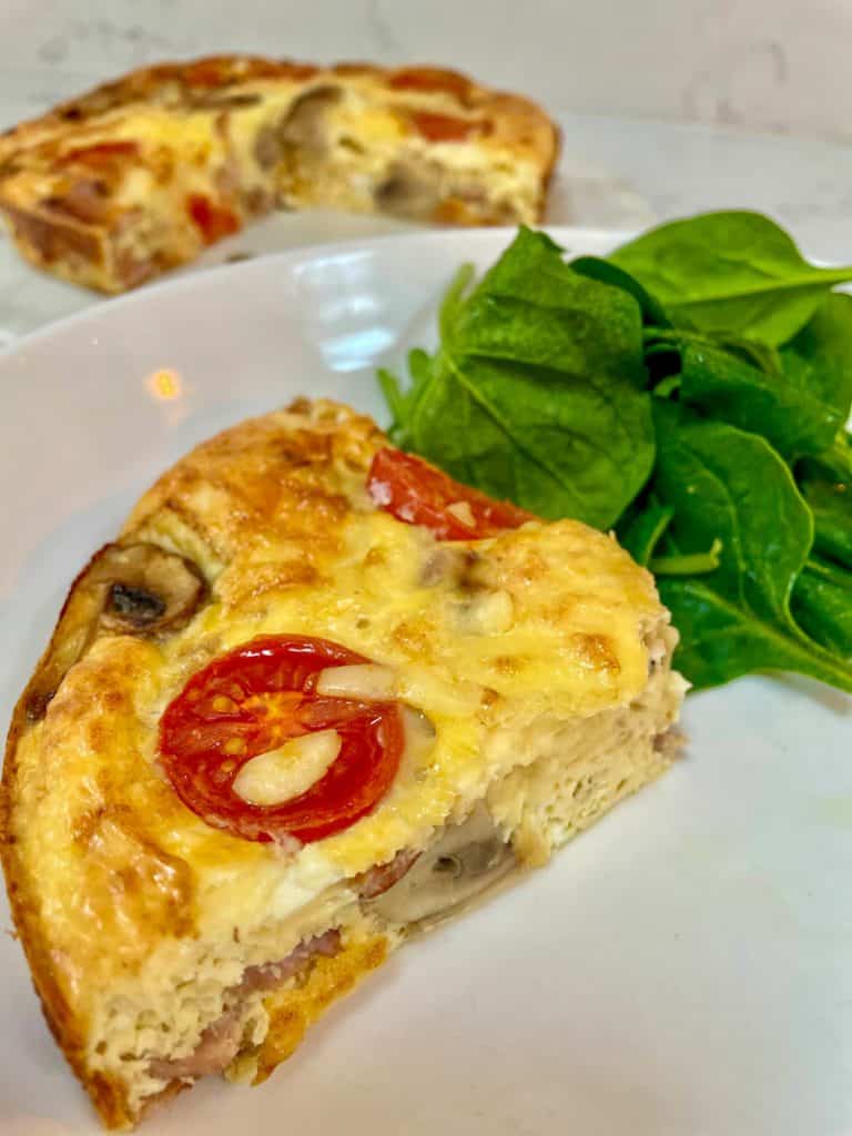 Crustless Quiche slimming style, slice served with spinach