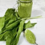 A jar of wild garlic pesto, wild garlic leaves