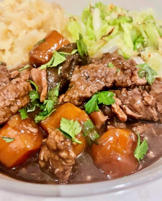 Slow cooker beef bourguignon - close up served with mash