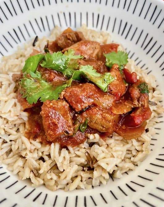 A bowl of served Slow cooker beef curry with rice