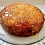 An orange pudding with oranges on top and syrup