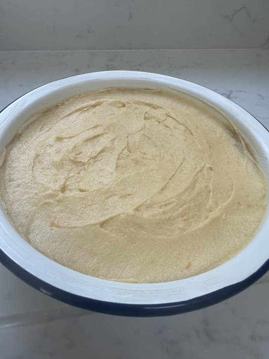 Orange pudding batter unbaked in tin 