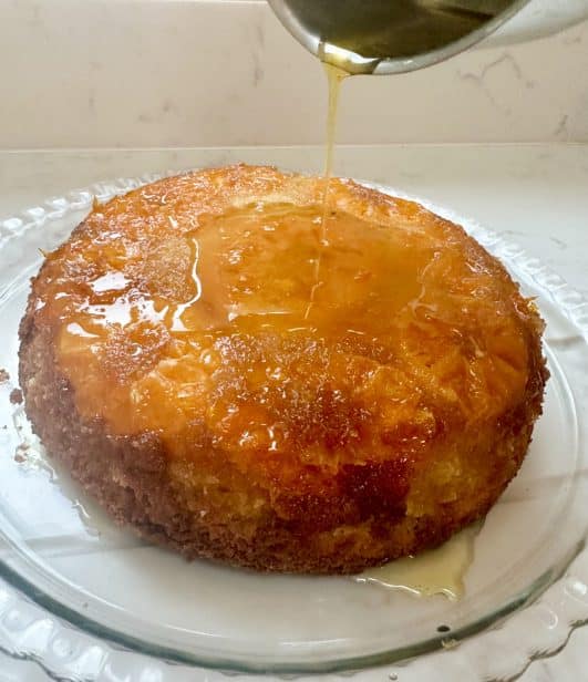 Orange pudding served with orange syrup