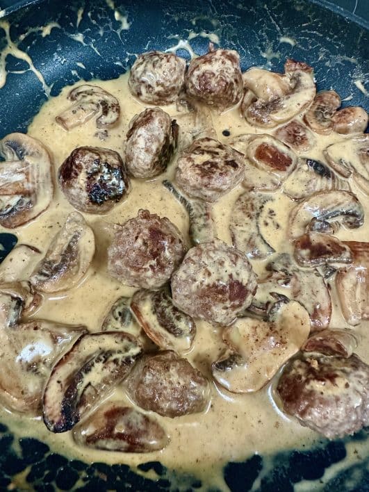 A pan full of meatballs & mushrooms