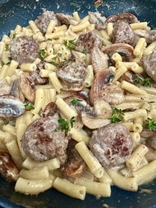 A bowl of meatballs, mushrooms and pasta