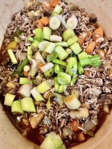 adding spring onions to dirty rice