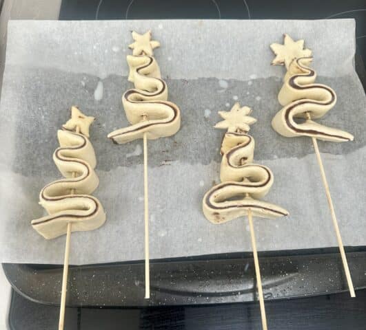 four unbaked puff pastry Christmas Trees